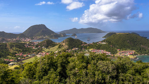 High angle view of townscape by sea against sky