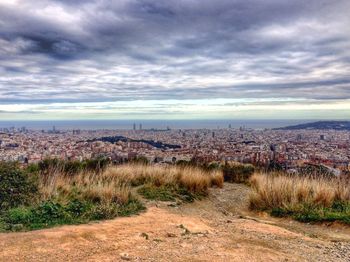 Cityscape against cloudy sky