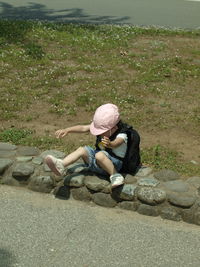 High angle view of woman sitting on land