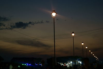 Low angle view of illuminated street light against sky at night