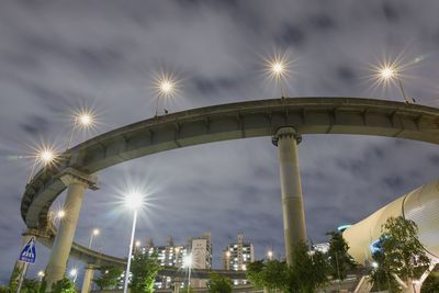 Low angle view of illuminated bridge against sky at night