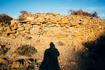 Shadow of person on land in desert