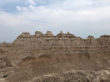 Low angle view of rock formations against sky