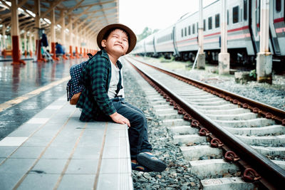 Full length of man standing at railroad station