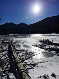 Scenic view of lake and mountains against sky during winter