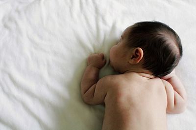 High angle view of baby girl on bed