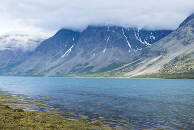 Scenic view of lake and mountains against sky