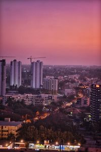 High angle view of illuminated buildings against sky at dusk