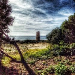 Scenic view of sea against cloudy sky