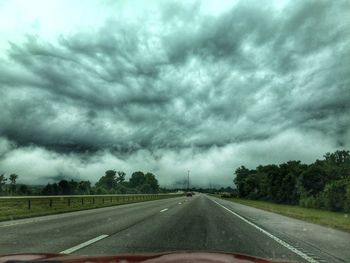 Road passing through dramatic sky