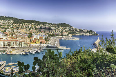 High angle view of townscape by sea against sky