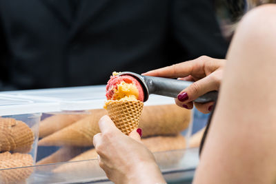 Midsection of woman holding ice cream