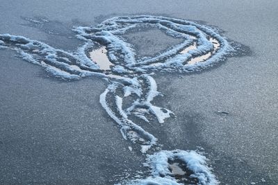 High angle view of footprints on frozen land