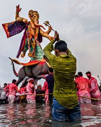 Rear view of people in lake