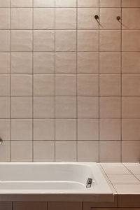 Low section of woman standing in bathroom