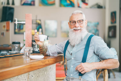 Portrait of man wearing glasses on table