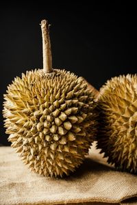 Close-up of fruit on table against black background
