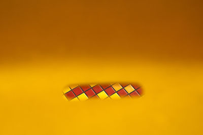 Directly above shot of multi colored pencils against yellow background