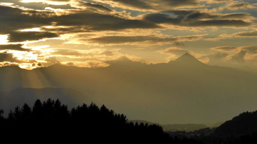 Scenic view of silhouette mountains against sky at sunset