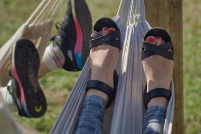 Low section of people relaxing on hammocks