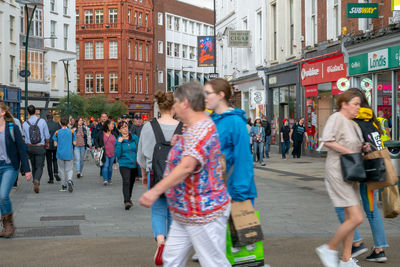 Group of people walking on city street