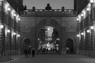 People walking in city at night