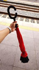 Low section of woman holding umbrella