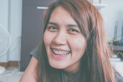 Portrait of smiling woman at home