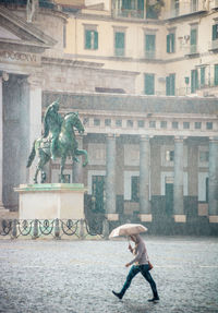 Statue against building in city