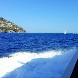 Scenic view of sea against clear blue sky