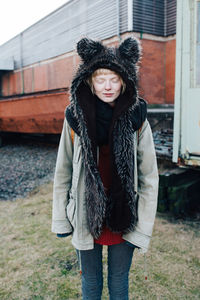 Portrait of young woman standing outdoors