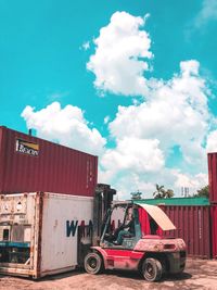 Cars parked at roadside against blue sky