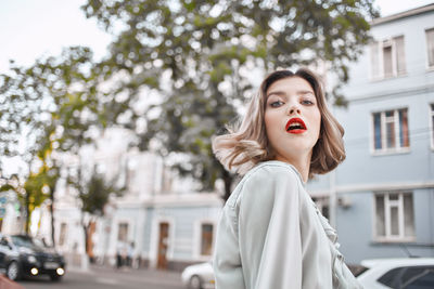 Portrait of a beautiful young woman in city