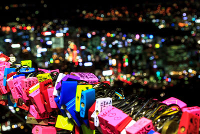 Close-up of padlocks in city at night