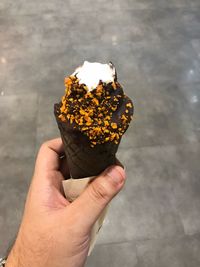 Close-up of hand holding ice cream