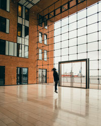 Rear view of man walking by building