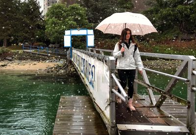 Full length of woman on wet rainy day