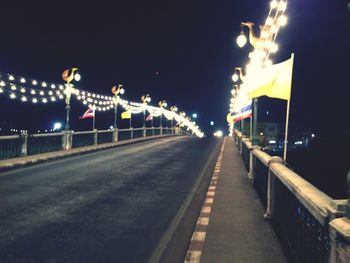 View of illuminated street lights at night