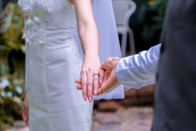 Bouquet in the hands of the groom. to make a happy wedding gift to a young bride.