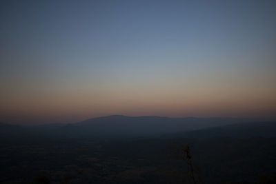 Scenic view of silhouette mountains against sky during sunset