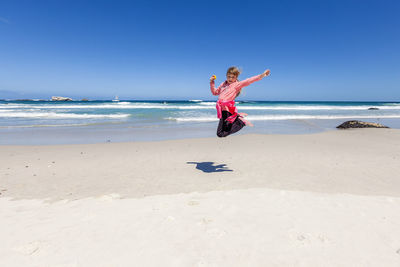 Full length of person on beach against sky