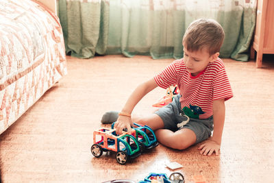 Boy playing with toy car