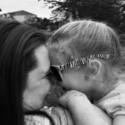 Close-up of cheerful mother and daughter with face to face