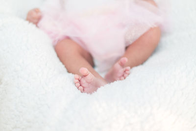 Low section of baby girl on bed