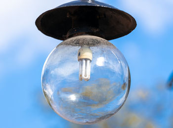 Low angle view of light bulb against sky