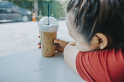 Close-up portrait of girl drinking glass