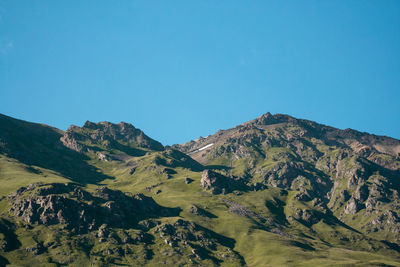 Scenic view of mountains against clear blue sky