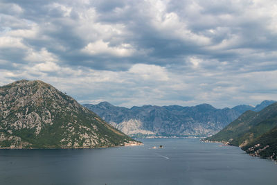 Scenic view of sea and mountains against sky