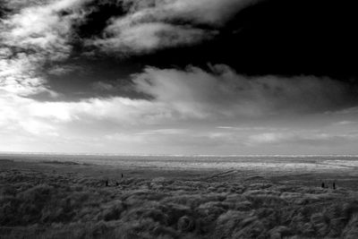 Scenic view of landscape against cloudy sky