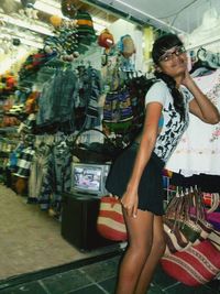 Full length of woman wearing sunglasses standing at market